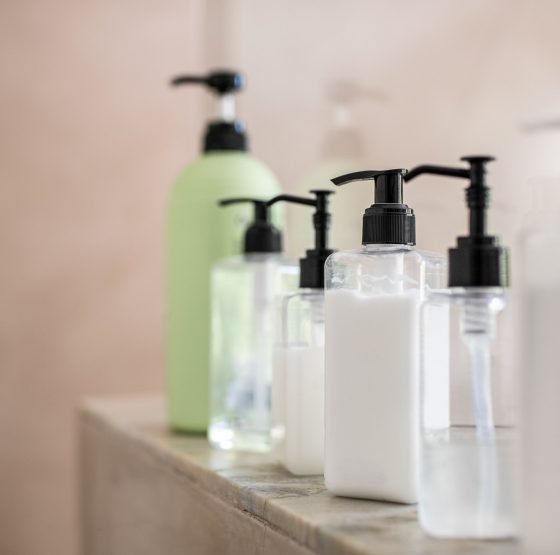 Dispenser bottles of moisturizer at spa