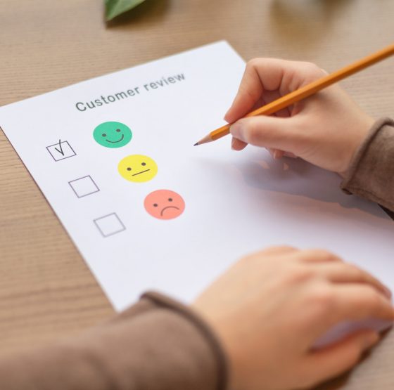 Female ticking on happy smiley face as excellent service